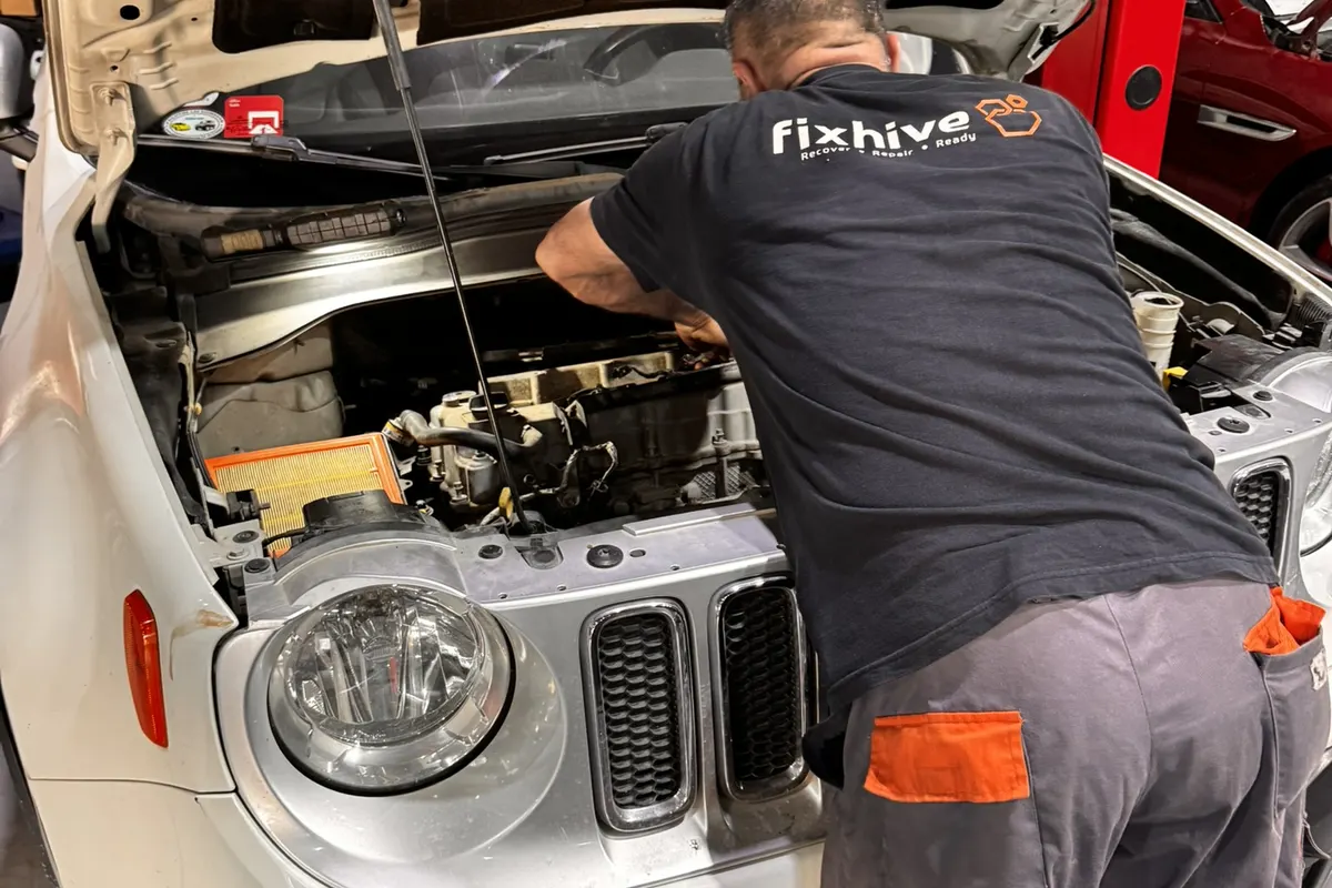 Two FixHive mechanics removing gearbox from lifted 4x4 SUV in Dubai Investment Park